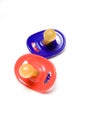 Colorful pacifiers on white