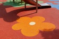 padded rubber sport and safety floor. playing area with red and orange flower pattern Royalty Free Stock Photo