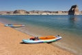 Colorful paddle boards pulled up on the sandy beach at Lake Powell