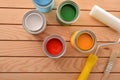 Colorful paint cans on wooden boards for work at home Royalty Free Stock Photo