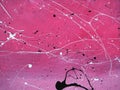 Paint drops on a pink wall abstract