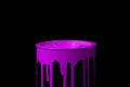 Pink oil paint flowing over the part of metal bucket. Isolated over black background Royalty Free Stock Photo