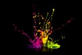 Colorful paint splashing on audio speaker isolated on black background Royalty Free Stock Photo
