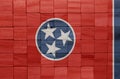 colorful painted big national flag of tennessee state on a wooden cubes texture