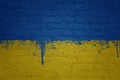 colorful painted big national flag of ukraine on a massive brick wall Royalty Free Stock Photo