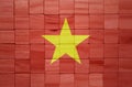 colorful painted big national flag of vietnam on a wooden cubes texture