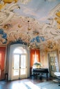 Colorful painted ceiling with stucco and chandelier of a luxurious ancient villa. Lake Como, Italy