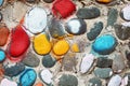 Colorful painted cobble stones on the textured surface of a pebble stone wall Royalty Free Stock Photo