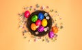 Colorful painted Easter Egg Nest with orange pastel colored background top view, Happy Easter Holliday concept background with