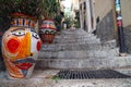 colorful painted vases and flower pots on narrow stairs in the old town of Taormina, Sicily