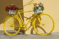 Colorful painted yellow bicycle decorated with flowers Royalty Free Stock Photo