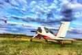 Colorful painting of light aircraft plane parked at a grass airfield