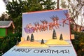 Colorful painting of Santa Claus, reindeer and Merry Christmas letters in International Drive area.