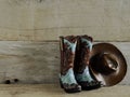 Cowboy boots and hat on wood background Royalty Free Stock Photo