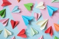 Colorful paper airplanes on pastel pink and blue colored background Royalty Free Stock Photo