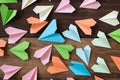 Colorful paper airplanes on wooden table background