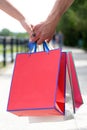 Colorful paper bags in hands of couple. Shopping bags Royalty Free Stock Photo