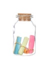 Colorful paper in the bottle with cork isolated on white Royalty Free Stock Photo