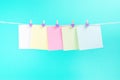 Colorful paper cards hanging rope isolated on blue background. Royalty Free Stock Photo