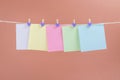 Colorful paper cards hanging rope isolated on brown background. Royalty Free Stock Photo