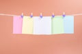 Colorful paper cards hanging rope isolated on brown background Royalty Free Stock Photo