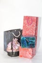 Colorful paper carry bags and a silk cloth pouch