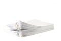 Colorful paper clip with pile of overload white paperwork isolated on white
