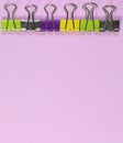 Colorful paper clip on pink millennial background. Space to insert the text.