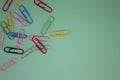 Colorful Paper Clips on a Blue Background. Office Business Tool. Items for the Office and Doing Business