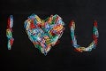 Colorful paper clips forming an alphabets and heart shape Royalty Free Stock Photo