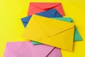 Colorful paper envelopes on yellow background. Mail service