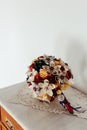 Colorful paper flower wedding bouquet on top, with a white wall in the background Royalty Free Stock Photo