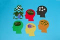 5 colorful paper heads, different leaves and petals in each head, creative concept teamwork everyone