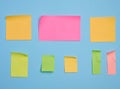 Colorful paper memo holders on blue background, space for writing data, notes Royalty Free Stock Photo