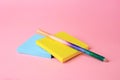 Colorful paper notes with erasable pen on pink background, closeup
