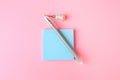 Colorful paper notes with erasable pen on pink background, top view