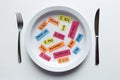 Colorful paper notes naming food additives on plate with fork and knife, food additive and unhealthy food concept