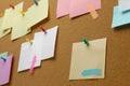 Colorful paper notes pinned to cork board, closeup Royalty Free Stock Photo