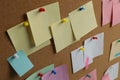 Colorful paper notes pinned to cork board Royalty Free Stock Photo