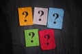 Colorful paper notes with question marks on black board Royalty Free Stock Photo