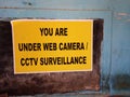 A colorful paper notice mentioning that we are under Web or cctv camera.