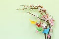 Colorful paper origami birds on flowering branches of cherry Royalty Free Stock Photo