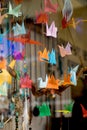 Colorful paper origami birds tied to strings Royalty Free Stock Photo