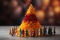 Colorful paper people form a human pyramid, celebrating teamwork and diversity Royalty Free Stock Photo