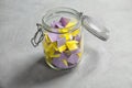 Colorful paper pieces for lottery in glass jar