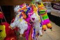 Colorful paper pinatas hanging inside a Mexican market