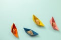 Colorful paper ships on blue background Royalty Free Stock Photo