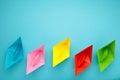 Colorful paper ships on blue background, Leadership and Business competition concepts. Copy space Royalty Free Stock Photo