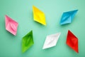 Colorful paper ships on mint background, Leadership and Business competition concepts Royalty Free Stock Photo