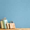 Colorful paper shopping bags on wooden table Royalty Free Stock Photo